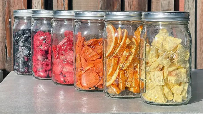 A rainbow colored array of freeze dried goods in Mason jars.